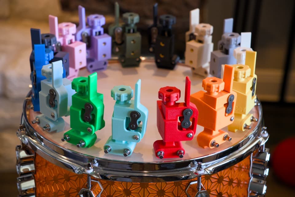Colorful Robot Throwoff One prototypes arranged on a drum shell.